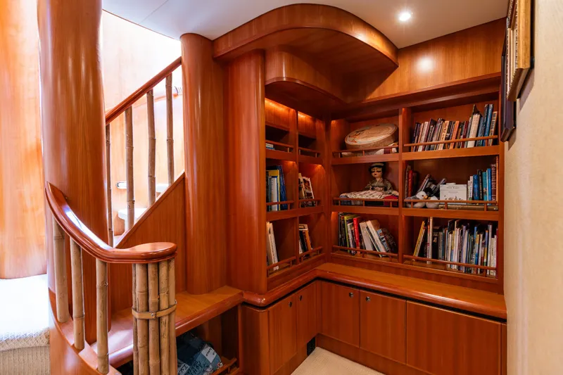 Slide: The Image of Luxurious wooden staircase and bookshelf in 2005 West Bay 86 Raised Pilothouse Motor Yacht. - 53