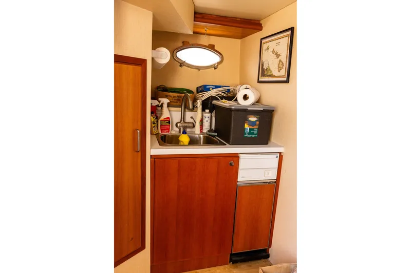 Slide: The Image of Small utility area in 2005 West Bay 86 Raised Pilothouse Motor Yacht with sink and storage. - 131