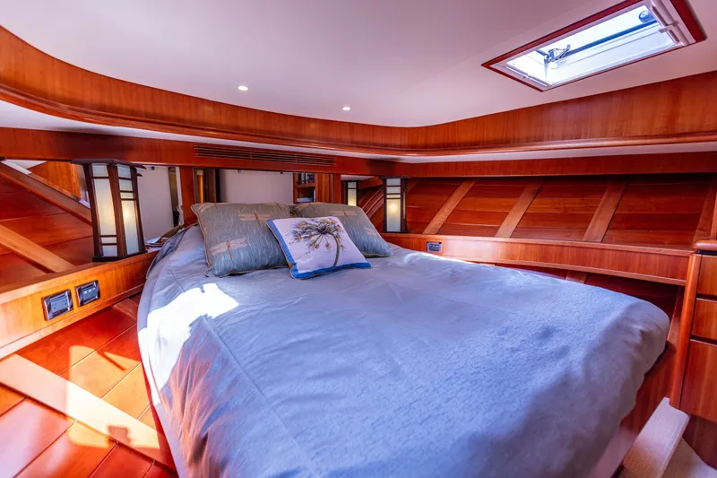 Slide: The Image of Luxurious bedroom in 2005 West Bay 86 Raised Pilothouse Motor Yacht with elegant wood finish. - 80