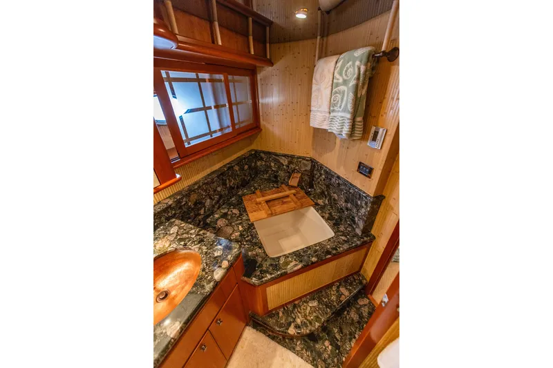 Slide: The Image of Luxurious bathroom in 2005 West Bay 86 Raised Pilothouse Motor Yacht with marble countertop. - 76