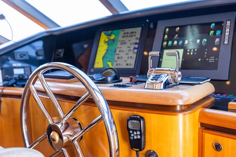 Slide: The Image of Pilothouse of 2005 West Bay 86 Raised Motor Yacht with navigation screens and controls. - 42