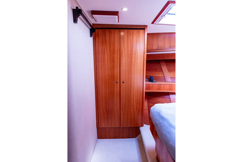 Slide: The Image of Luxurious wooden interior of 2005 West Bay 86 Raised Pilothouse Motor Yacht cabin. - 83