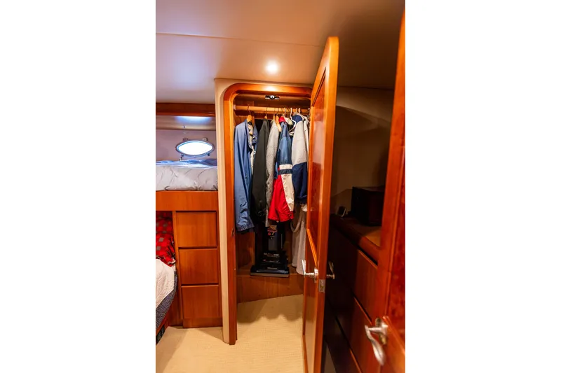 Slide: The Image of Cozy cabin closet in 2005 West Bay 86 Raised Pilothouse Motor Yacht. - 82