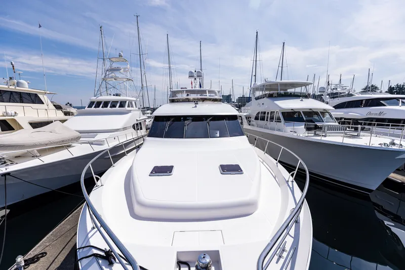 Slide: The Image of 2005 West Bay 86 Raised Pilothouse Motor Yacht docked among other luxury boats. - 153