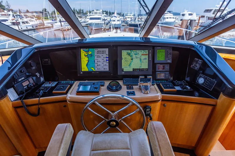 Slide: The Image of Pilothouse of 2005 West Bay 86 Yacht with navigation screens and steering wheel. - 40