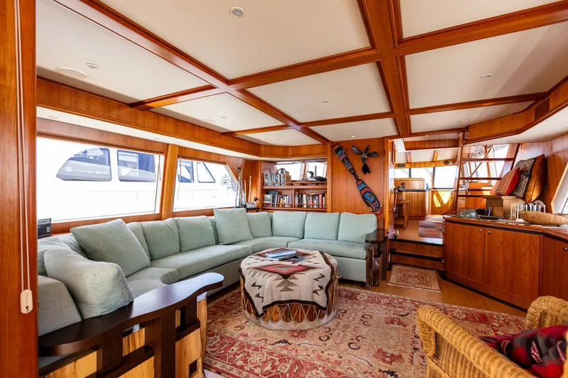 Slide: The Image of Luxurious 2005 West Bay 86 yacht interior with elegant wood finishes and spacious seating area. - 15