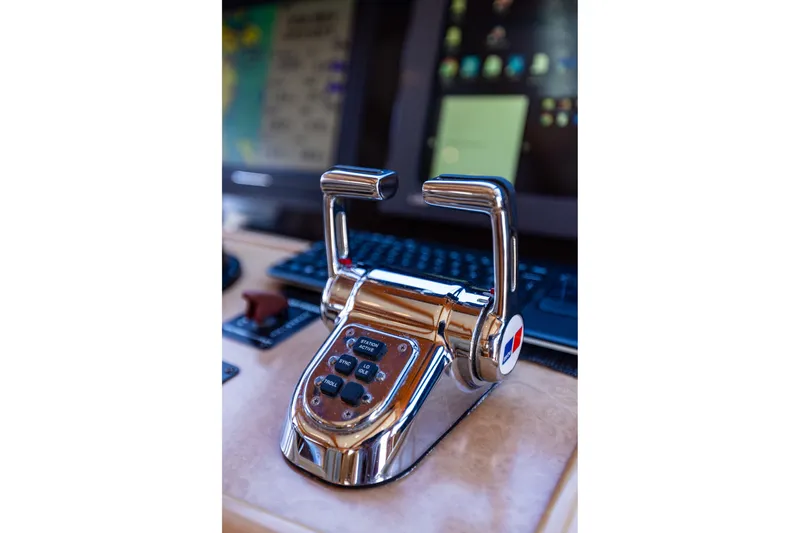Slide: The Image of Throttle controls on 2005 West Bay 86 Raised Pilothouse Motor Yacht's helm station. - 102