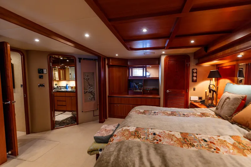 Slide: The Image of Luxurious bedroom interior of 2005 West Bay 86 Raised Pilothouse Motor Yacht, featuring elegant wood finishes. - 59