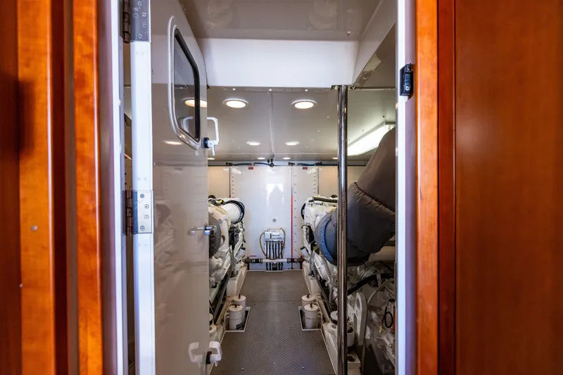 Slide: The Image of Engine room of 2005 West Bay 86 Raised Pilothouse Motor Yacht, featuring dual engines. - 111