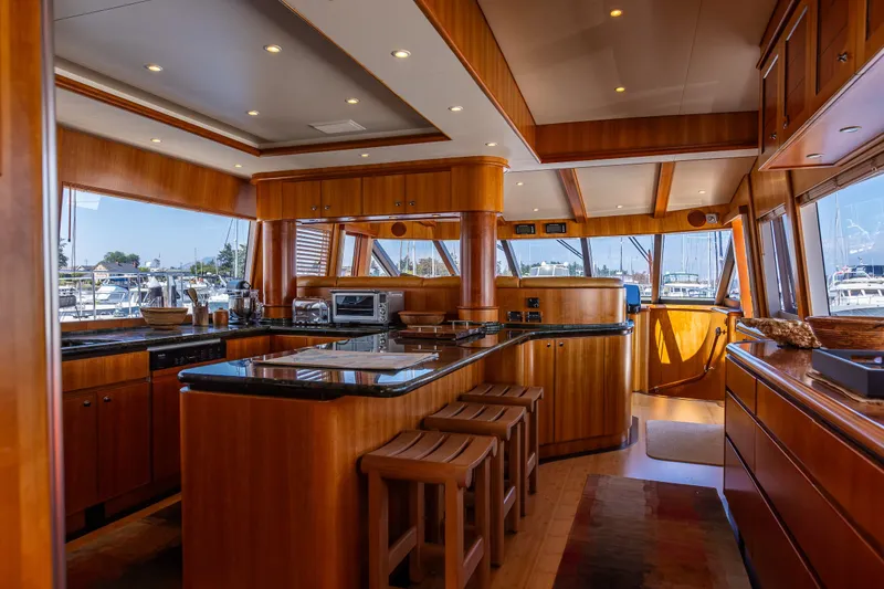 Slide: The Image of Luxurious interior of 2005 West Bay 86 Raised Pilothouse Motor Yacht with elegant wood finishes. - 21