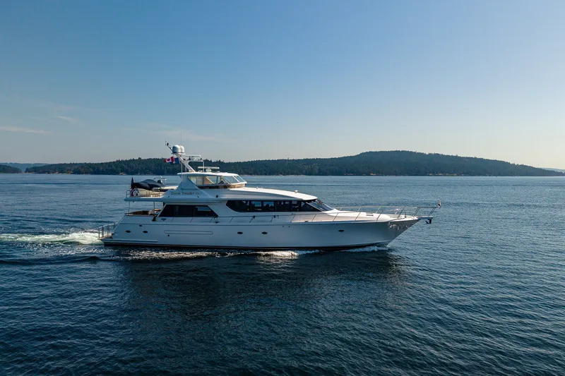 Slide: The Image of 2005 West Bay 86 Raised Pilothouse Motor Yacht cruising on calm waters. - 154