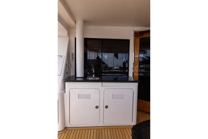 Slide: The Image of Interior view of 2005 West Bay 86 Raised Pilothouse Motor Yacht with cabinetry and window. - 13