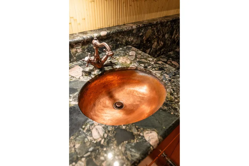 Slide: The Image of Copper sink with marble countertop in 2005 West Bay 86 Raised Pilothouse Motor Yacht. - 74