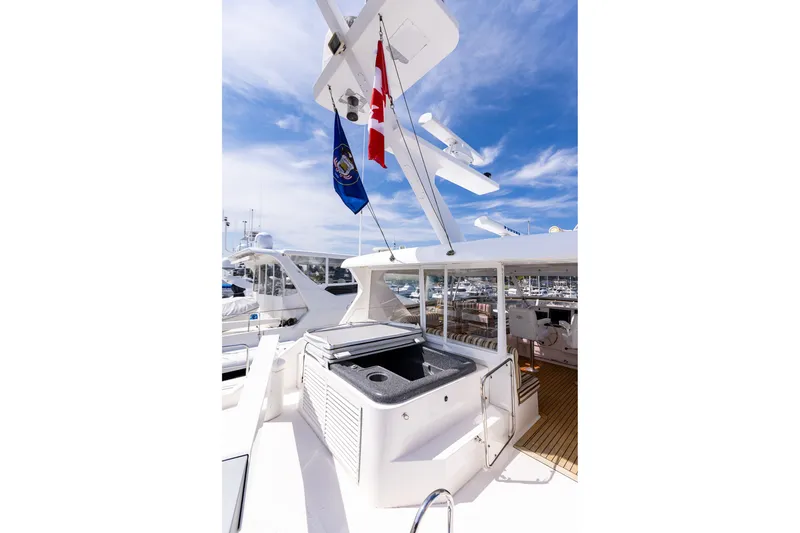 Slide: The Image of 2005 West Bay 86 Raised Pilothouse Motor Yacht deck with flags and seating area. - 103