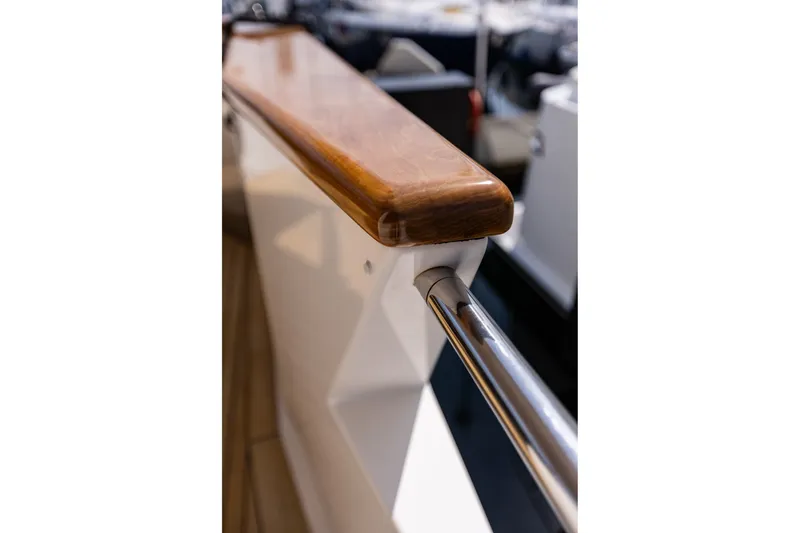 Slide: The Image of Close-up of polished wood and metal railing on 2005 West Bay 86 Raised Pilothouse Motor Yacht. - 148