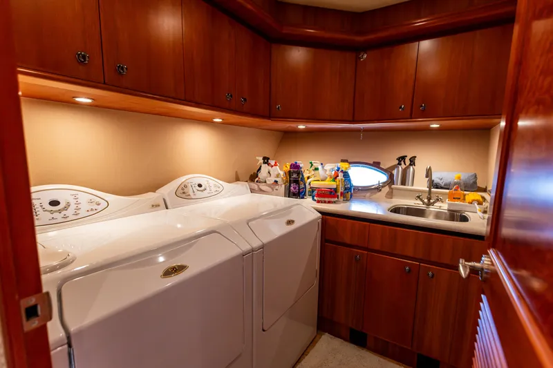 Slide: The Image of Laundry room in 2005 West Bay 86 Raised Pilothouse Motor Yacht with washer, dryer, and sink. - 92