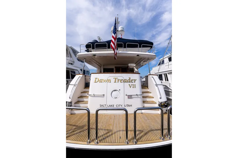 Slide: The Image of 2005 West Bay 86 Raised Pilothouse Motor Yacht, "Dawn Treader VII," docked with American flag. - 109
