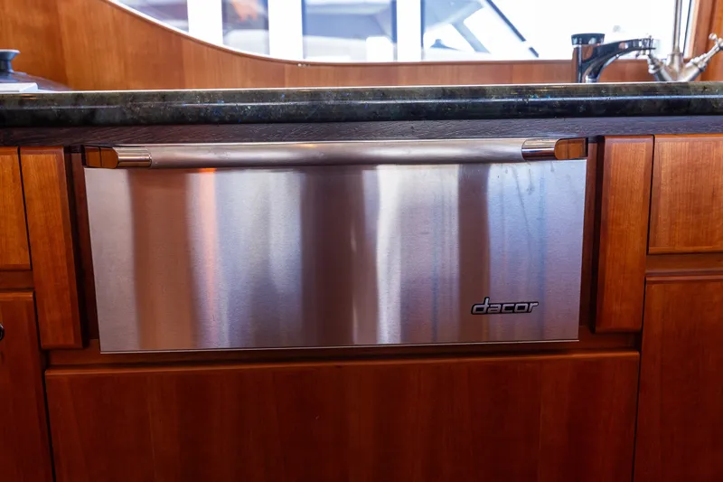 Slide: The Image of Stainless steel Dacor dishwasher in 2005 West Bay 86 Raised Pilothouse Motor Yacht kitchen. - 26