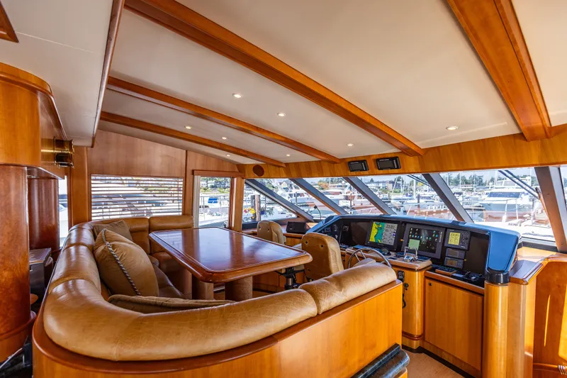 Slide: The Image of Luxurious interior of 2005 West Bay 86 Raised Pilothouse Motor Yacht with leather seating and navigation equipment. - 34