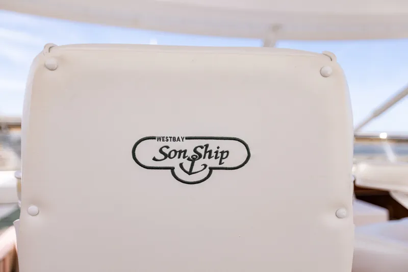 Slide: The Image of White seat with "West Bay SonShip" logo on a 2005 motor yacht. - 161