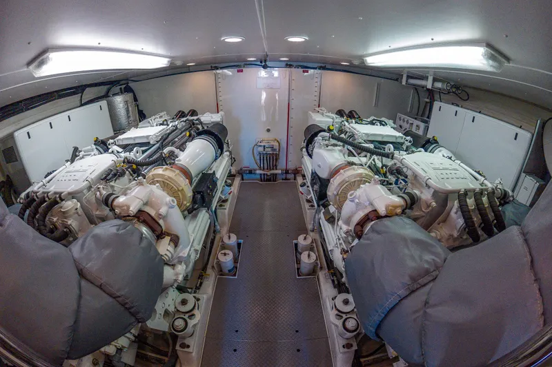 Slide: The Image of Engine room of 2005 West Bay 86 Raised Pilothouse Motor Yacht, featuring dual engines. - 117