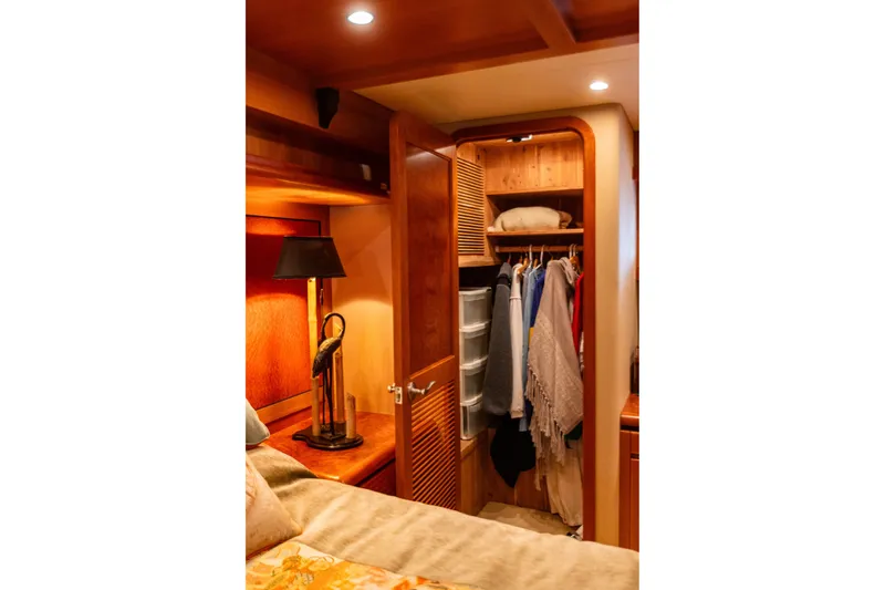 Slide: The Image of Luxurious wooden closet interior on 2005 West Bay 86 Raised Pilothouse Motor Yacht. - 77