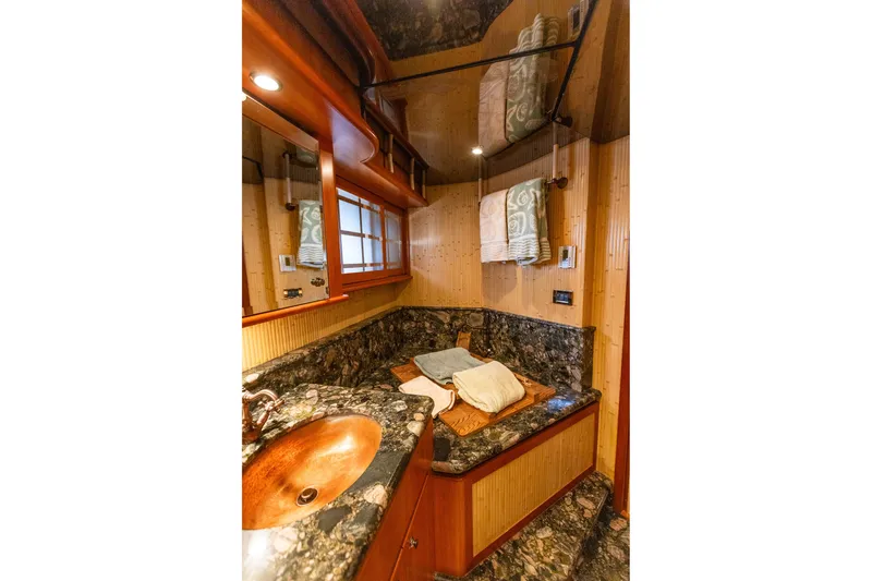 Slide: The Image of Luxurious bathroom in 2005 West Bay 86 Raised Pilothouse Motor Yacht with elegant marble countertop. - 72