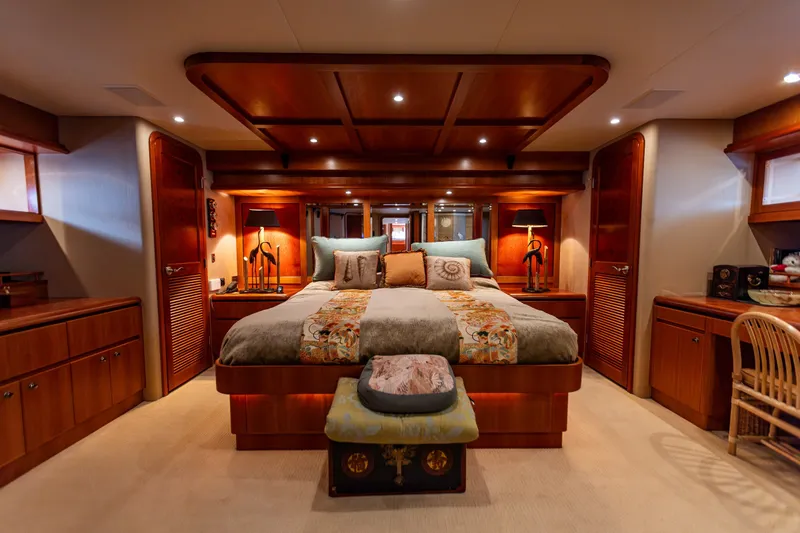 Slide: The Image of Luxurious bedroom interior of 2005 West Bay 86 Raised Pilothouse Motor Yacht, featuring elegant wood finishes. - 56