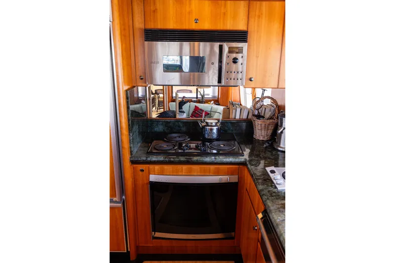 Slide: The Image of Luxurious kitchen in 2005 West Bay 86 Raised Pilothouse Motor Yacht with modern appliances. - 28