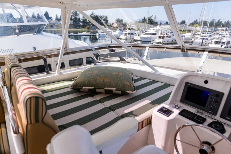 Slide: The Image of Luxurious 2005 West Bay 86 Raised Pilothouse Motor Yacht interior with striped seating and navigation controls. - 97
