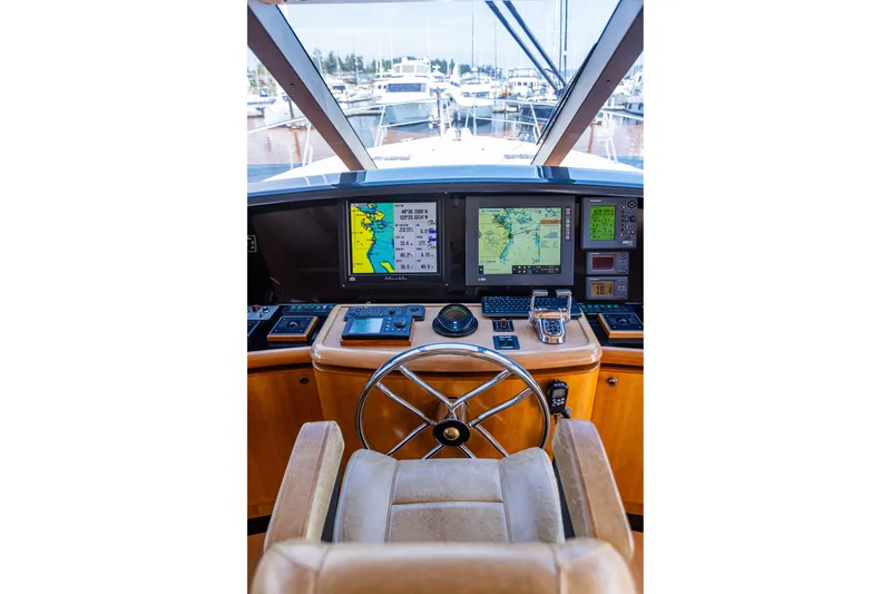 Slide: The Image of Pilothouse of 2005 West Bay 86 Raised Motor Yacht with navigation screens and steering wheel. - 44