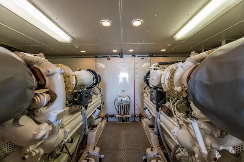 Slide: The Image of Engine room of 2005 West Bay 86 Raised Pilothouse Motor Yacht, showcasing dual engines. - 115