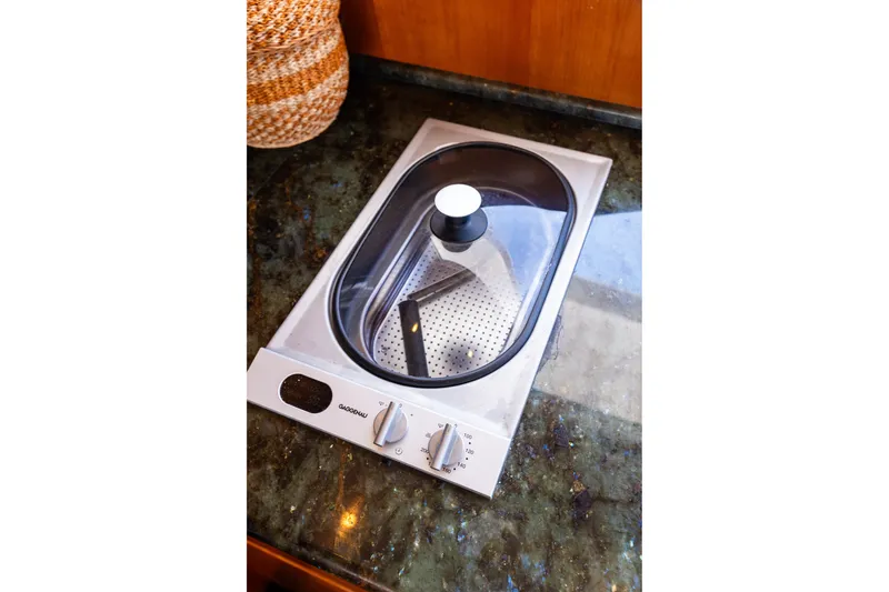 Slide: The Image of Built-in stovetop on 2005 West Bay 86 Raised Pilothouse Motor Yacht kitchen counter. - 29