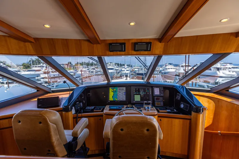 Slide: The Image of Luxurious 2005 West Bay 86 Raised Pilothouse Motor Yacht helm with marina view. - 41
