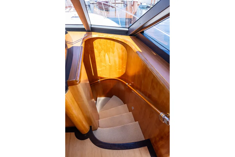 Slide: The Image of Luxurious wooden staircase inside 2005 West Bay 86 Raised Pilothouse Motor Yacht. - 52