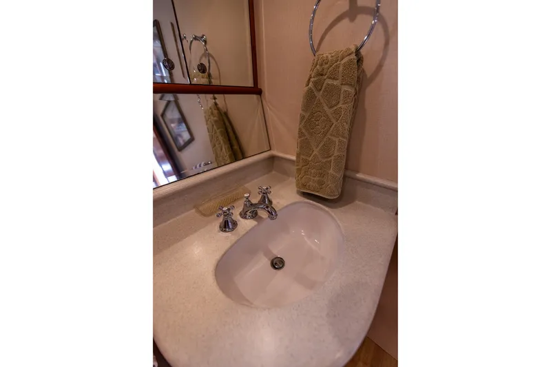 Slide: The Image of Elegant bathroom sink in 2005 West Bay 86 Raised Pilothouse Motor Yacht. - 90
