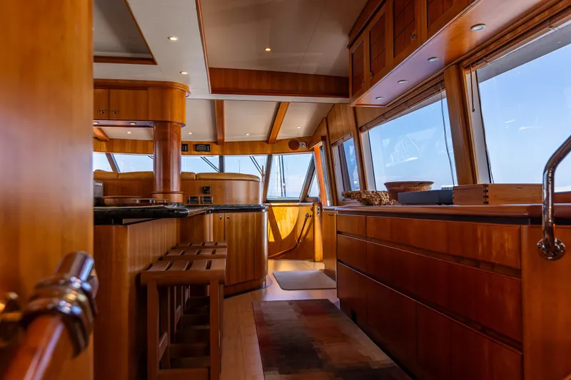 Slide: The Image of Luxurious interior of 2005 West Bay 86 Raised Pilothouse Motor Yacht with wooden finishes. - 20