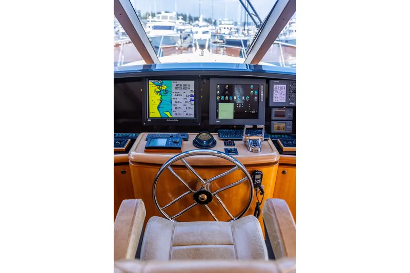 Slide: The Image of Pilothouse of 2005 West Bay 86 Raised Motor Yacht with navigation screens and steering wheel. - 43