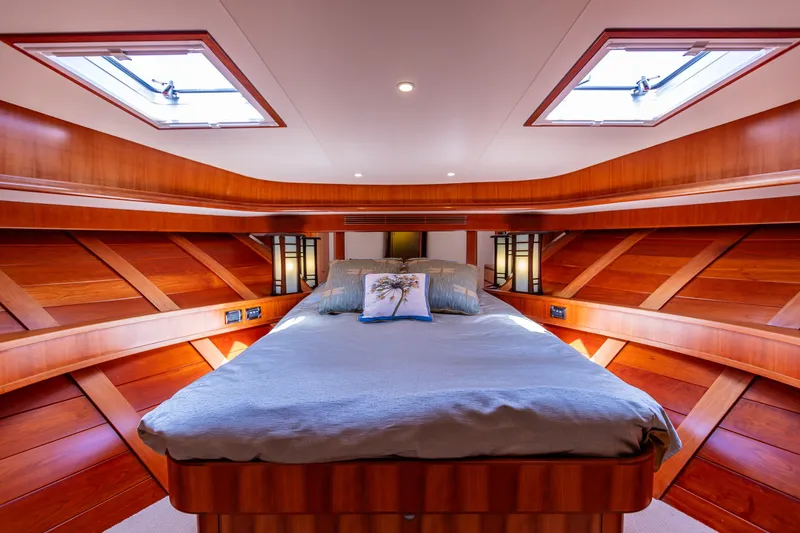 Slide: The Image of Luxurious bedroom in 2005 West Bay 86 Raised Pilothouse Motor Yacht, featuring elegant wood paneling. - 79