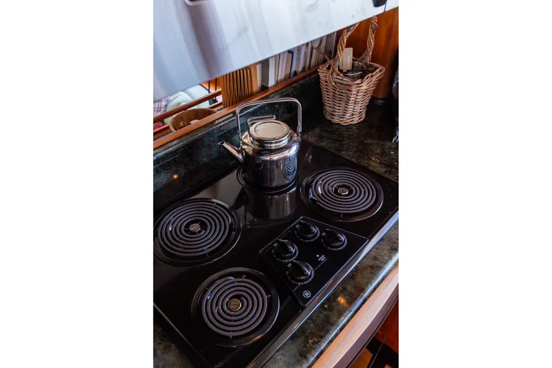 Slide: The Image of Stovetop with kettle in 2005 West Bay 86 Raised Pilothouse Motor Yacht kitchen. - 27