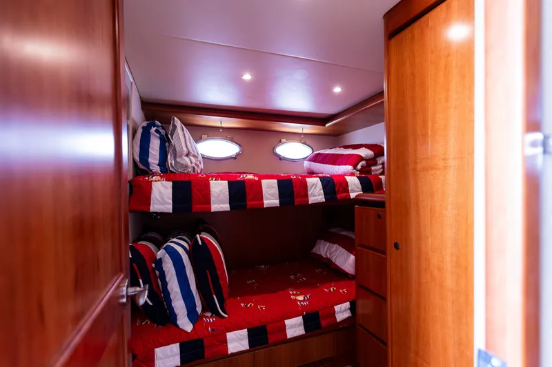 Slide: The Image of Bunk beds in 2005 West Bay 86 Raised Pilothouse Motor Yacht cabin, featuring nautical-themed bedding. - 137