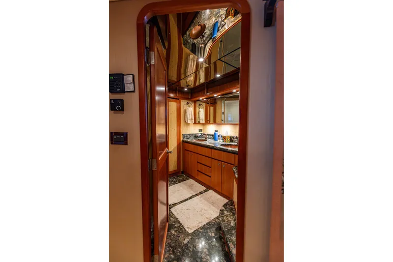 Slide: The Image of Luxurious bathroom interior of 2005 West Bay 86 Raised Pilothouse Motor Yacht with elegant wood finishes. - 140