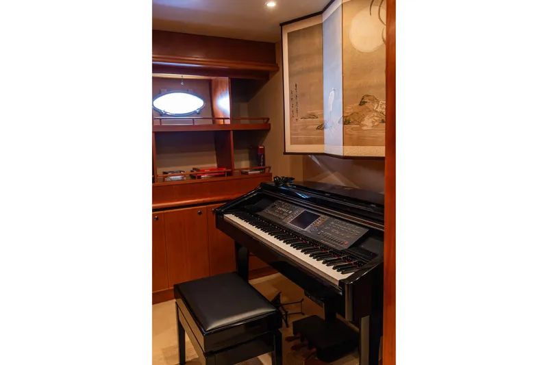 Slide: The Image of Luxurious yacht interior with piano, elegant wood paneling, and artistic wall hanging. - 66