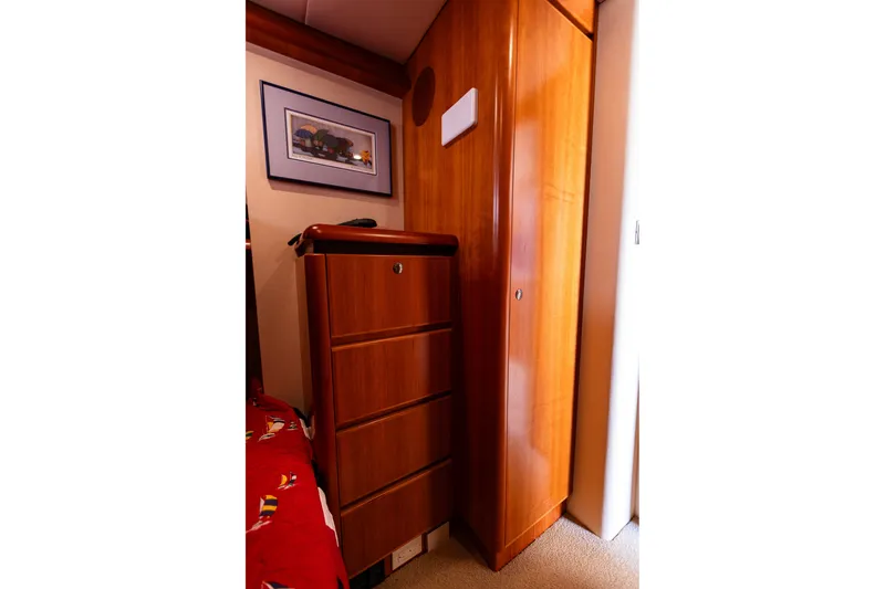Slide: The Image of Interior of 2005 West Bay 86 Yacht with wooden cabinetry and framed artwork. - 87