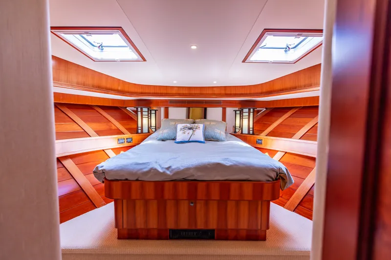 Slide: The Image of Luxurious bedroom in 2005 West Bay 86 Raised Pilothouse Motor Yacht with wood accents. - 78