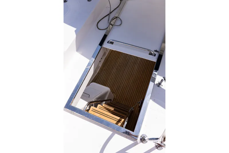 Slide: The Image of Hatch entrance with wooden steps on 2005 West Bay 86 Raised Pilothouse Motor Yacht. - 108