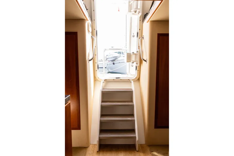 Slide: The Image of Stairway leading to the deck of a 2005 West Bay 86 Raised Pilothouse Motor Yacht. - 110
