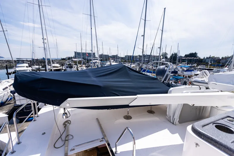 Slide: The Image of 2005 West Bay 86 Raised Pilothouse Motor Yacht docked in a marina. - 105