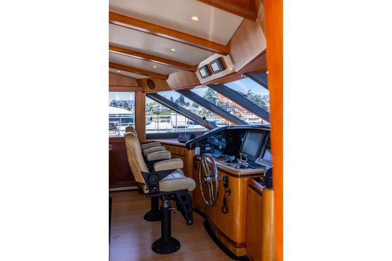 Slide: The Image of Pilothouse interior of 2005 West Bay 86 Raised Pilothouse Motor Yacht with helm and seating. - 45