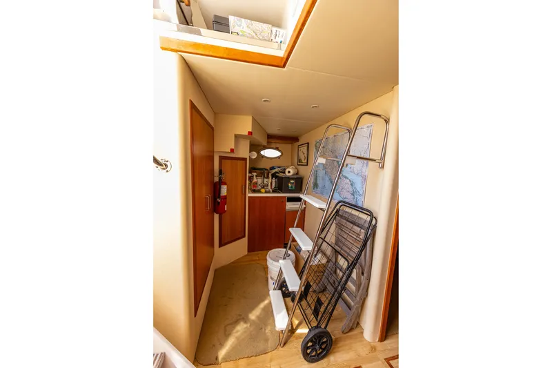 Slide: The Image of Interior of 2005 West Bay 86 Raised Pilothouse Motor Yacht with maps and equipment. - 132